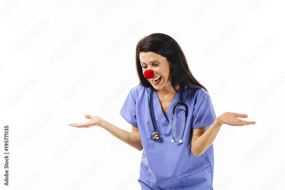 Portrait of a laughing female nurse or doctor with red nose Portrait of a laughing female nurse or doctor with red nose