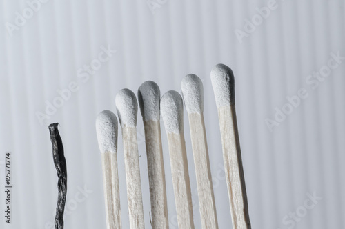 Grouped grey matchsticks in a row