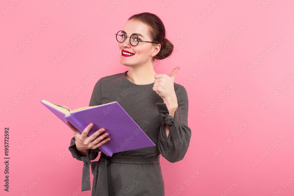 Businesswoman with hair bun and book