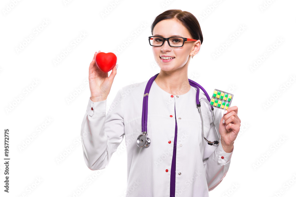 Young beautiful female doctor holding heart and pills in her hands on white background Young beautiful female doctor holding heart and pills in her hands on white background