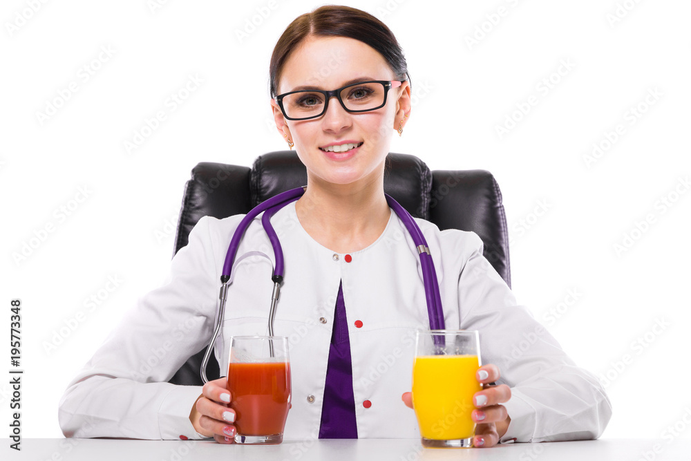 Female nutritionist sitting in her working place showing and offering glass of tomato and orange fresh juice on white background
