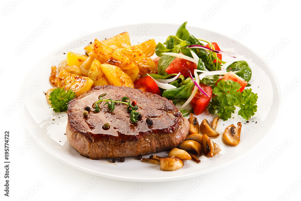 Grilled beef steak with baked potatoes and vegetables