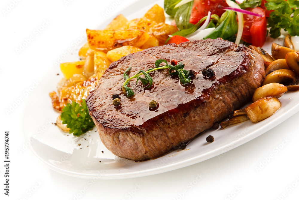 Grilled beefsteak with baked potatoes and vegetables