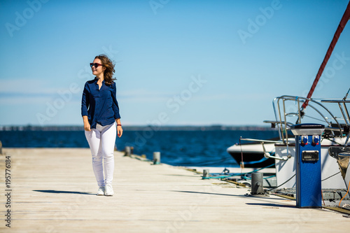 Young woman on vacation walking in harbor © Jacek Chabraszewski