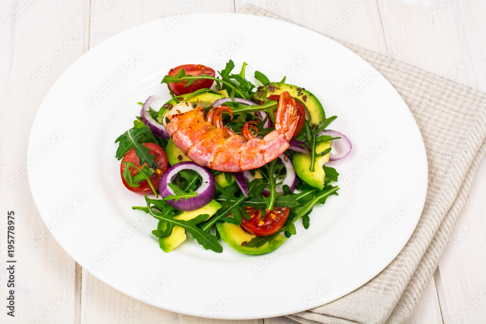 Salad with shrimps on white wooden table