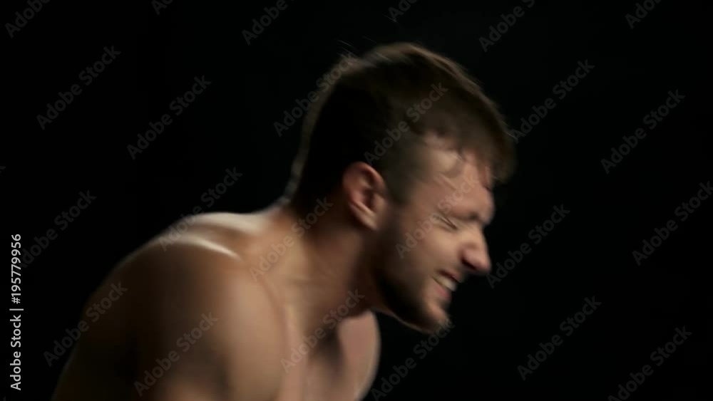 Young sweaty fighter is boxing. Confident male boxer in red gloves in fighting on ring. Efforts lead to success. Young sweaty fighter is boxing. Confident male boxer in red gloves in fighting on ring. Efforts lead to success.