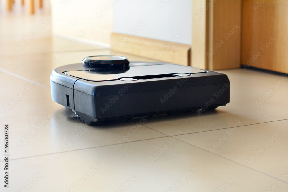 robotic vacuum cleaner on bright tiled floor robotic vacuum cleaner on bright tiled floor