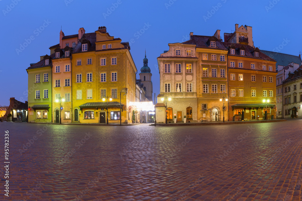 Castle Square with colorful houses, Piwna street and Bell tower of St. Martin's Church in Old town during morning blue hour, Warsaw, Poland.
