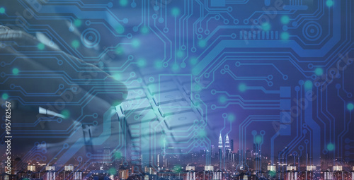 Woman hand on computer keyboard with credit card and eletronic circuit graphic.Symbolic of  online shopping,e-commerce,cyber crime and technology.