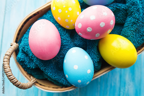 Easter eggs in the basket on rustic background