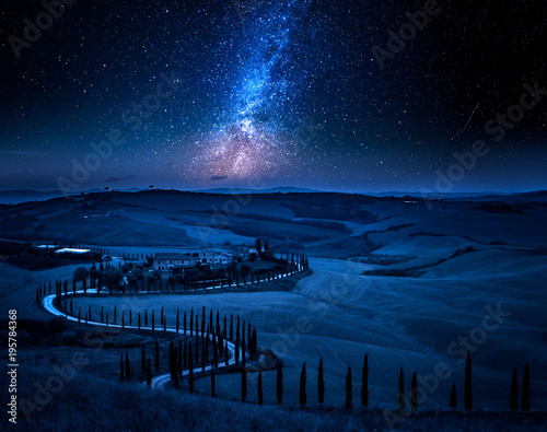 Milky way and winding road with cypresses, Tuscany