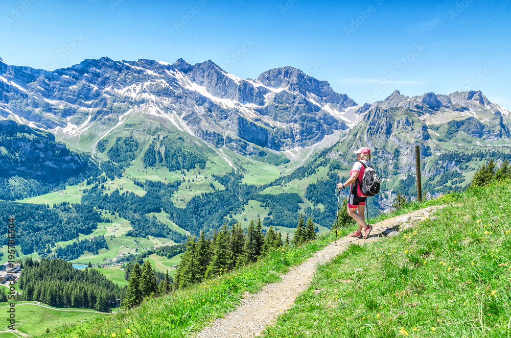 Swiss Alps. Man with walking sticks on the footpaths in the Alps. Engelberg Resort