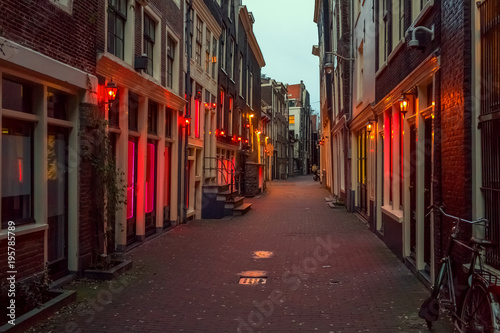 Red light district in Amsterdam, the Netherlands, night view. Windows and doors where prostitutes work