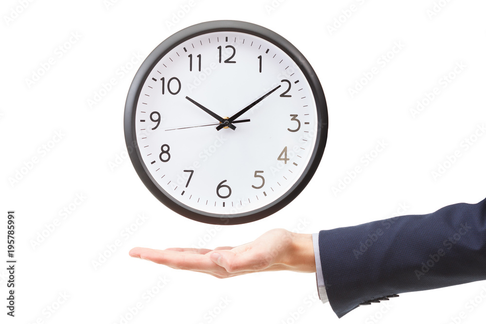 Businessman hand holding wall clock, time management