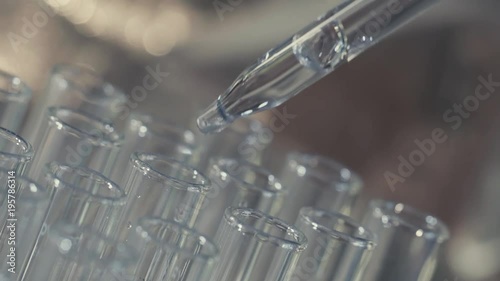 laboratory scientist working with a pipette analyzes and extract the DNA or molecules in the test tubes.on blue background