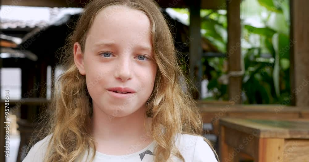 Portrait of a 10 - 11 year old girl smiling and looking at camera
