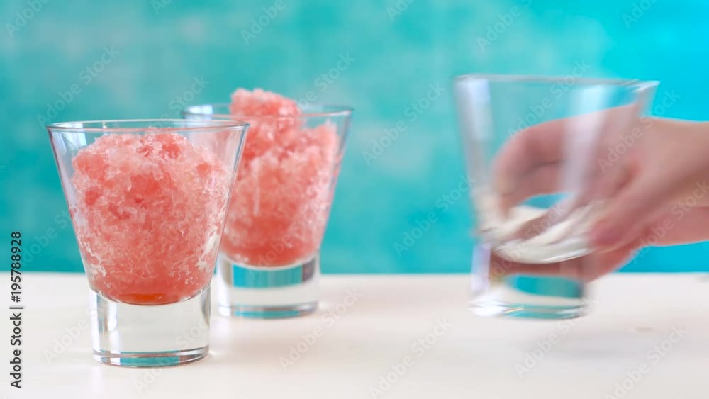 Preparing Summertime refreshing Watermelon granita desserts on a summery blue and white setting, time lapse. Preparing Summertime refreshing Watermelon granita desserts on a summery blue and white setting, time lapse.