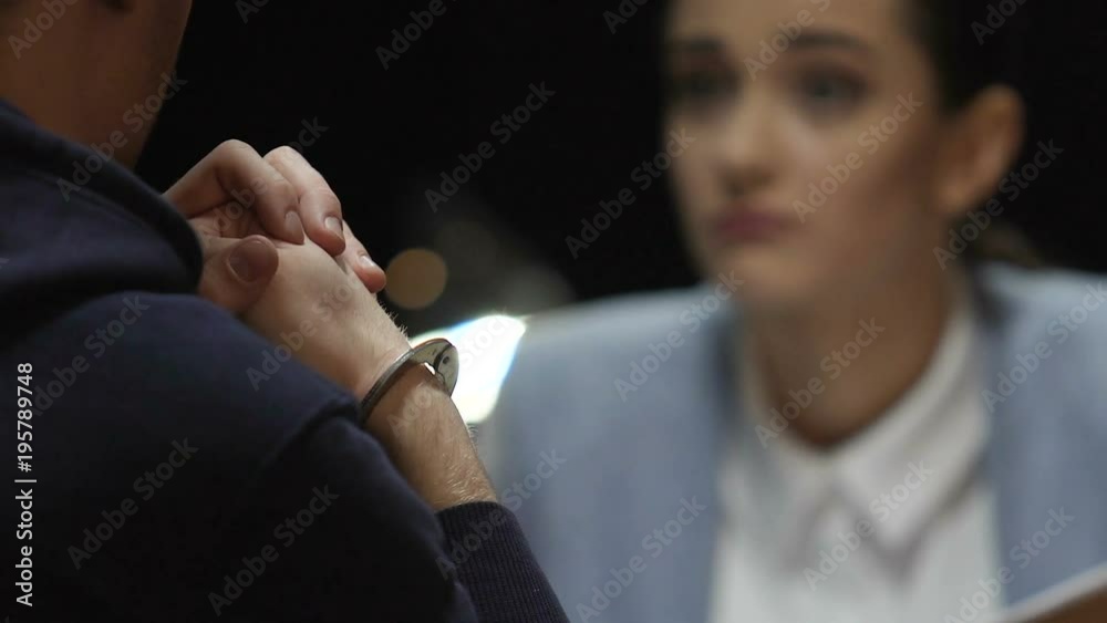Detective woman investigating crime and trying to force criminal for confession Detective woman investigating crime and trying to force criminal for confession