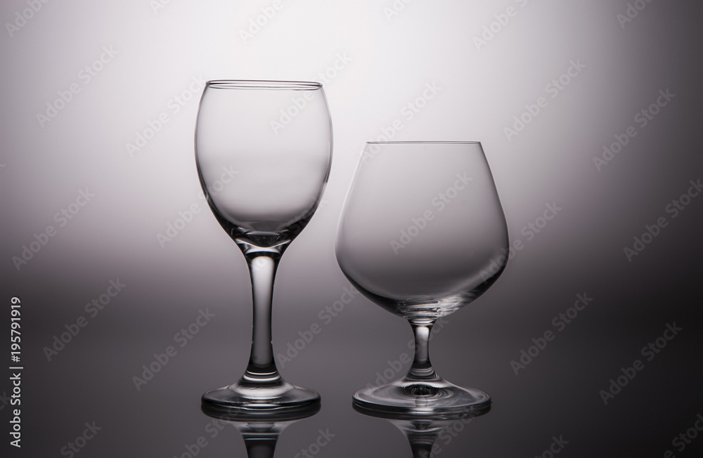 Wine and cognac glasses on a gray gradient background
