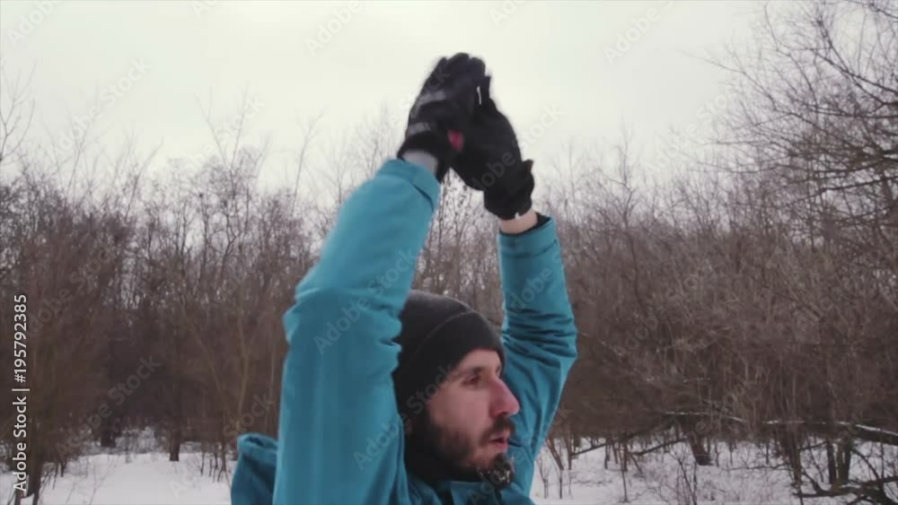 male athlete training in winter forest, trail runner, fit man do exercises in cold weather male athlete training in winter forest, trail runner, fit man do exercises in cold weather