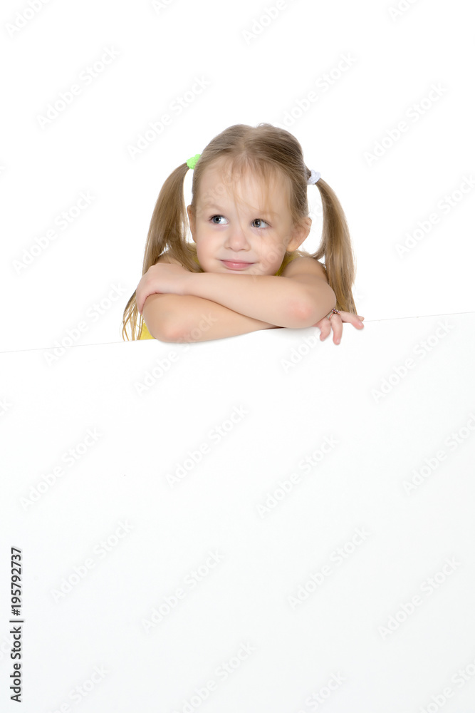 A little girl is looking from behind an empty banner. A little girl is looking from behind an empty banner.