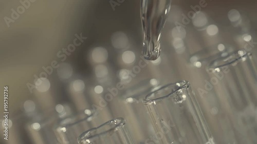 laboratory scientist working with a pipette analyzes and extract the DNA or molecules in the test tubes.on blue background