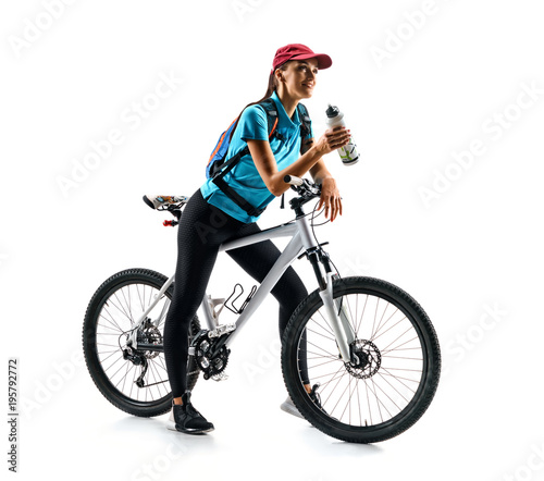 Cyclist in blue t-shirt with bicycle drinking a water in silhouette on white background. Sport and healthy lifestyle