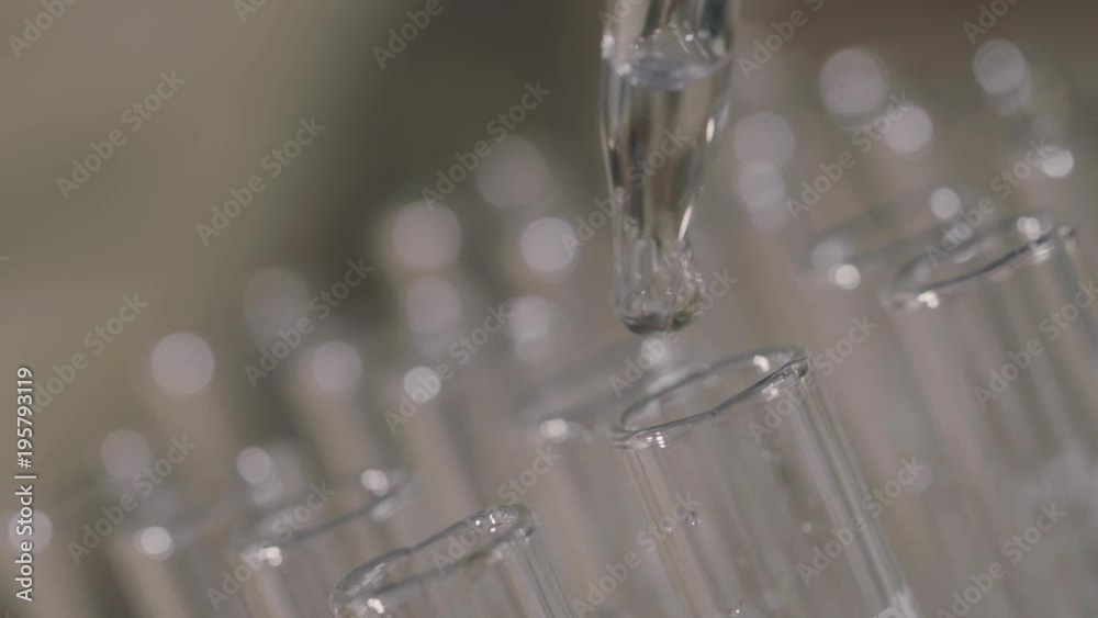 laboratory scientist working with a pipette analyzes and extract the DNA or molecules in the test tubes.on blue background
