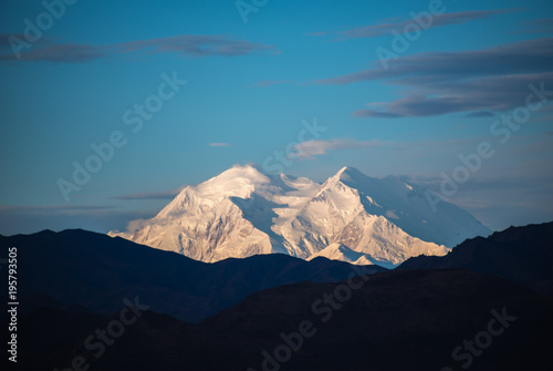 Early morning close-up of the snow-clad twin peaks of Mount Denali with the Harper Glacier between the peaks