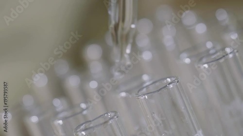laboratory scientist working with a pipette analyzes and extract the DNA or molecules in the test tubes.on blue background