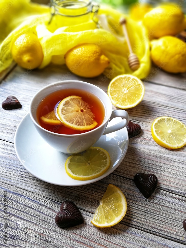 tea with lemons in a rustic style on white wooden background tea with lemons in a rustic style on white wooden background