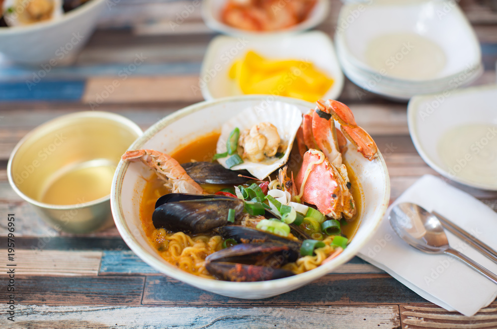 Seafood, Crab, Shrimp, Noodles in bowl. Table Setting. Seafood, Crab, Shrimp, Noodles in bowl. Table Setting.