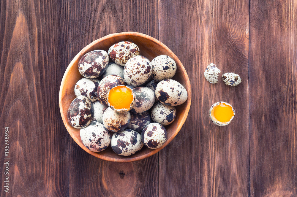 Quail Eggs on dark wooden background. Top view. Rustic scene. Quail Eggs on dark wooden background. Top view. Rustic scene.