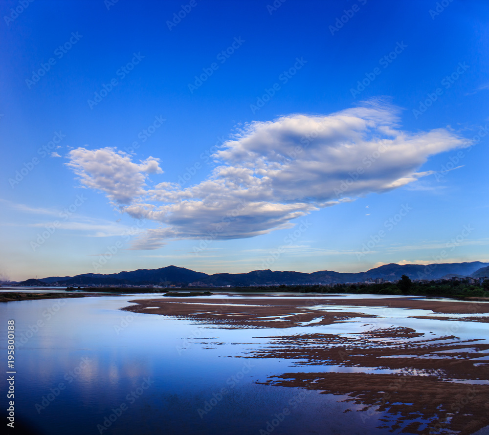 Riverbank sandbar on a bird shape cloud