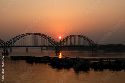 Yadanarbon bridge at sunset over Ayeyarwady River, Modern bridge in Mandalay division, Burma © nu_thai_image