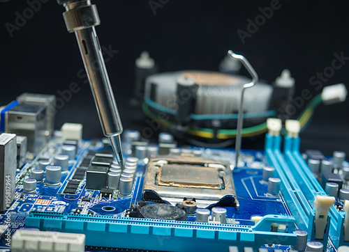 Repair of electronic devices, tin circuit with soldering iron, (spot focus)