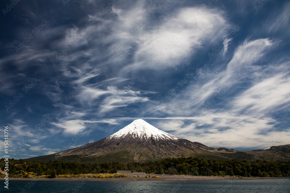 Fototapeta premium Osorno Volcano, a conical stratovolcano with dramatic cloudy blue sky in Los Lagos Region, Patagonia, Chile