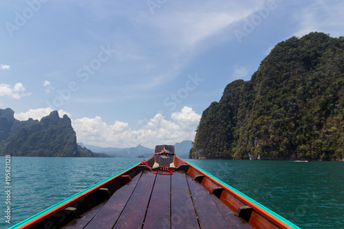 wooden boat sail on Ratchaprapa Dam , among the tropical islands  Khao Sok National Park  Thailand © suriya