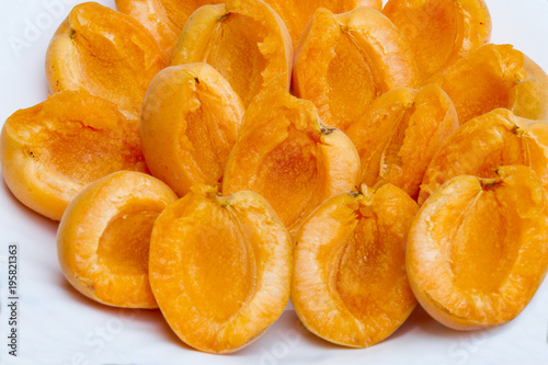 Peeled apricot on a plate. Peeled fresh apricot on a white plate without pits. Healthy and natural food. photo