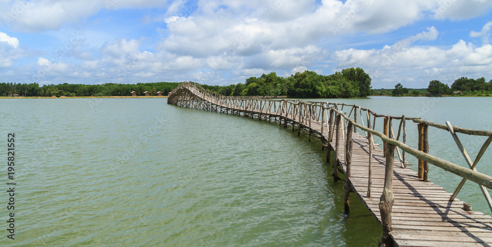 Wooden bridge across reservoir.