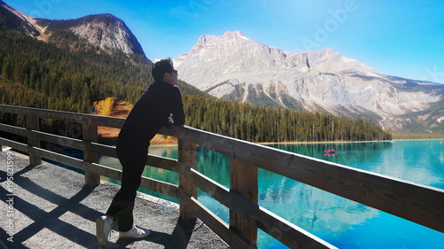 Asian man admiring beautiful lake view at Baff National Park, Canada photo