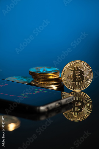 bitcoin with blue background and smartphone