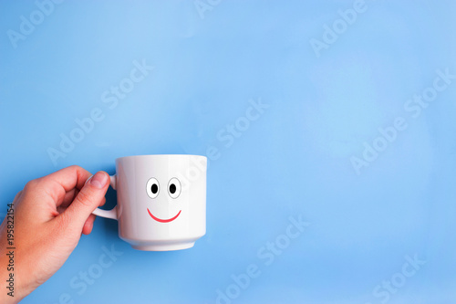 cup with eye and smile photo