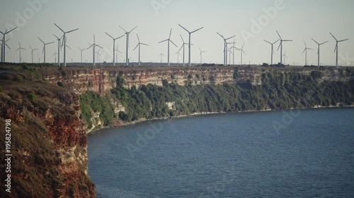 Wind power stations on cape Kaliakra, steep stone coast, Bulgaria photo