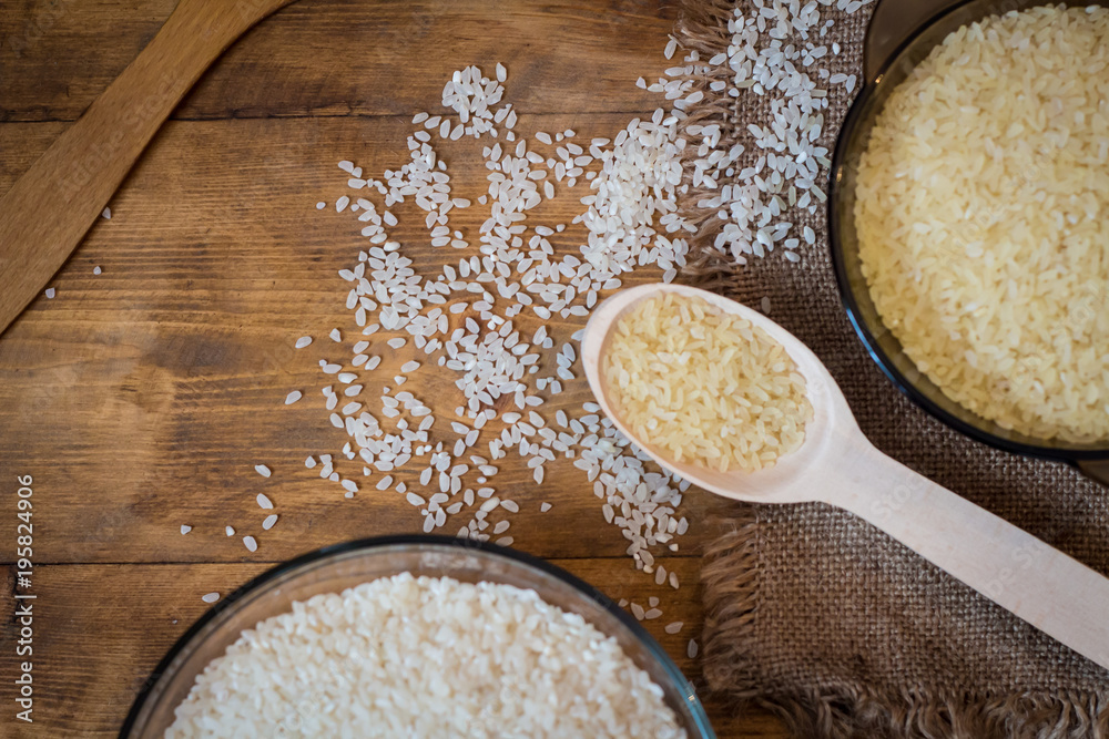 Rice. Steamed rice on wood background and burlap top view Rice. Steamed rice on wood background and burlap top view