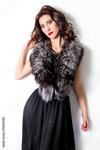 beautiful chic woman in dress and fur collar on white background
