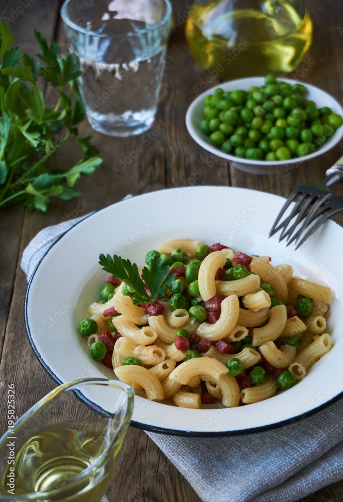 Pasta with green peas and sausage in a plate Pasta with green peas and sausage in a plate