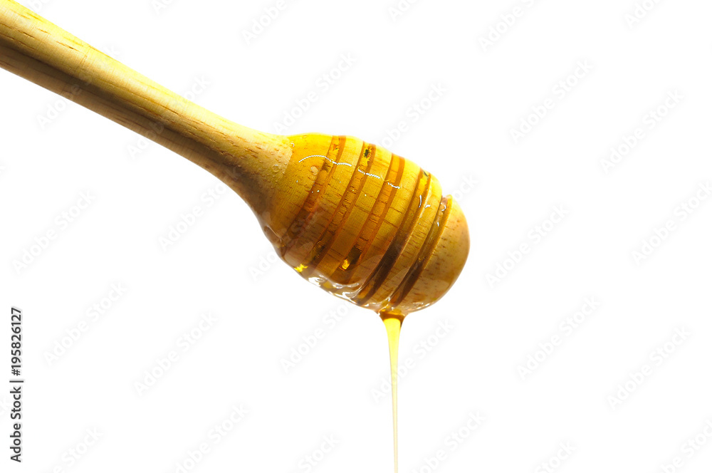 Dripping honey on wooden dipper or wooden spoon isolated on white background Dripping honey on wooden dipper or wooden spoon isolated on white background