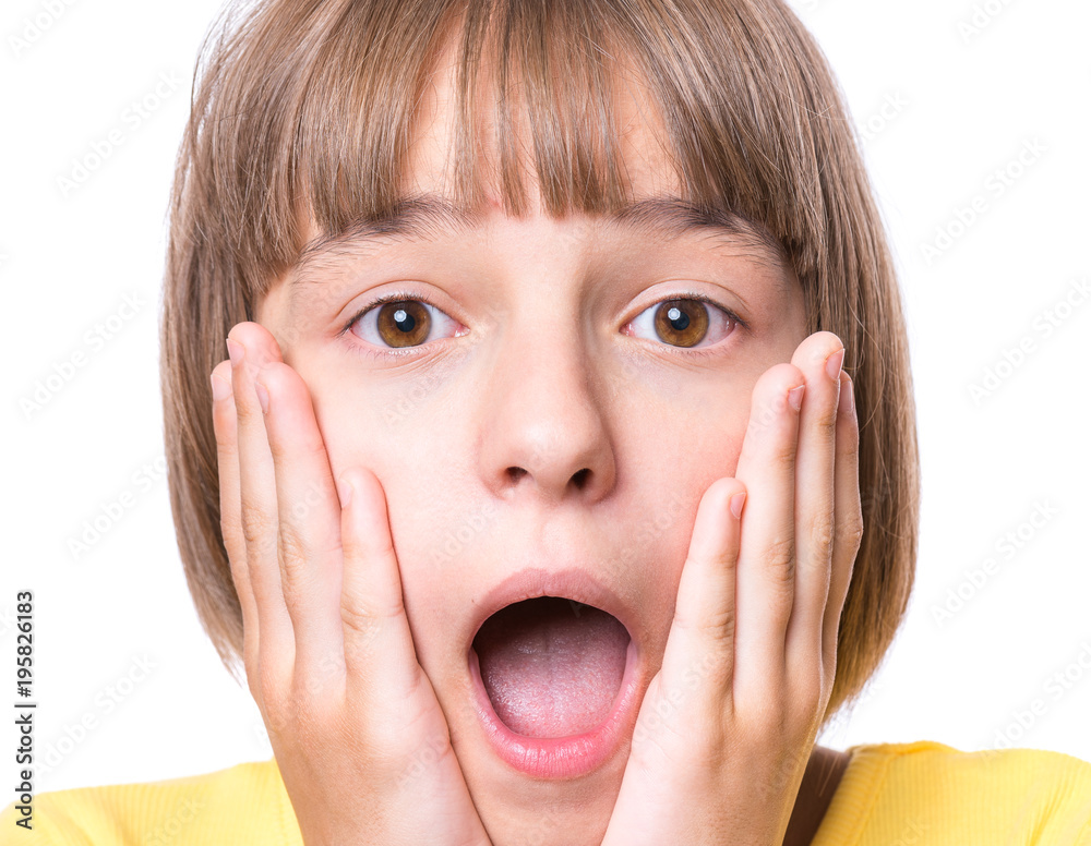 Emotional portrait of excited little girl. Funny cute surprised child 10 year old with mouth open in amazement. Portrait of shocked teenager, isolated on white background. Emotional portrait of excited little girl. Funny cute surprised child 10 year old with mouth open in amazement. Portrait of shocked teenager, isolated on white background.