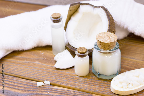 Natural herbal skin care products, top view ingredients coconut, essence oil on table concept of the best all natural face moisturizer. Facial treatment preparation background